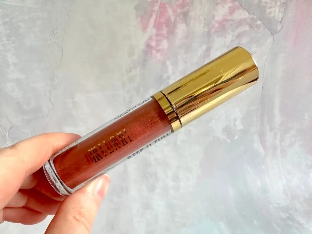 Milani Keep It Full Nourishing Lip Plumper in the shade Rosy Bronze, handheld.