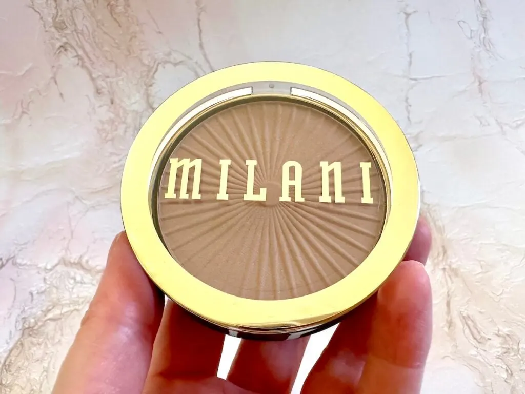 Milani Silky Matte Bronzing Powder in the shade Sun Kissed, handheld.