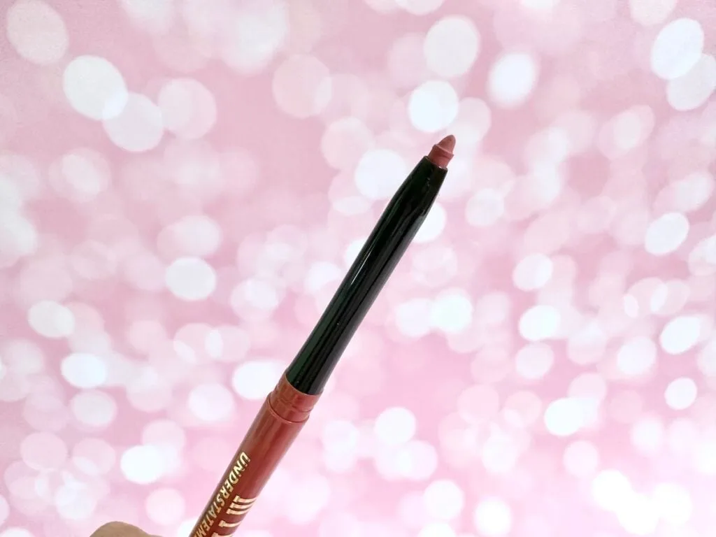 Milani Understatement Lipliner Pencil in Desert Rose, cap removed and handheld.