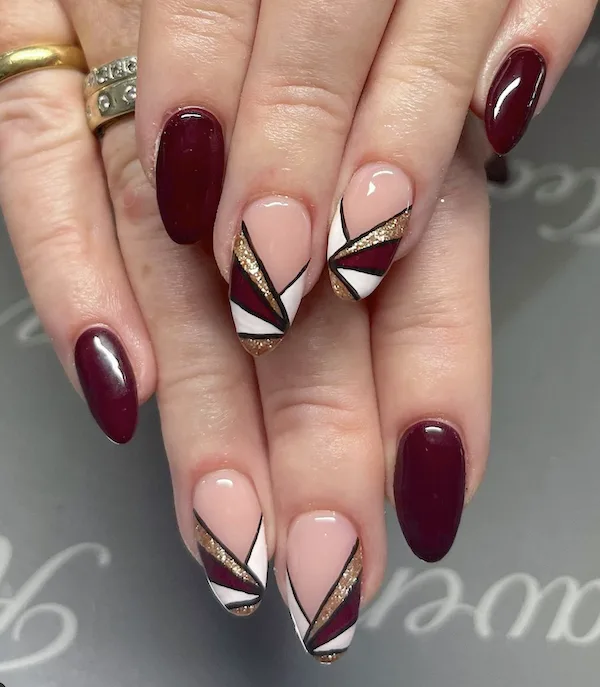 Burgundy and geometric French tip winter nails.