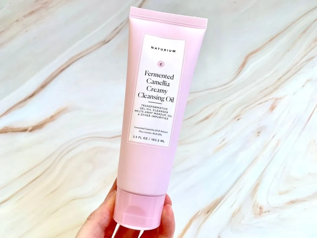 Naturium Fermented Camellia Creamy Cleansing Oil handheld.