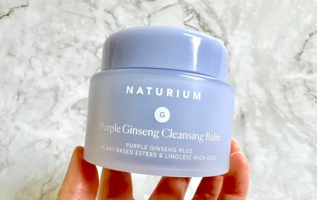 Naturium Purple Ginseng Cleansing Balm, handheld.