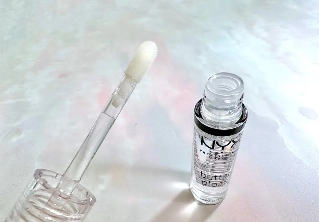 NYX Butter Gloss in the shade Sugar Glass, open tube with applicator wand.