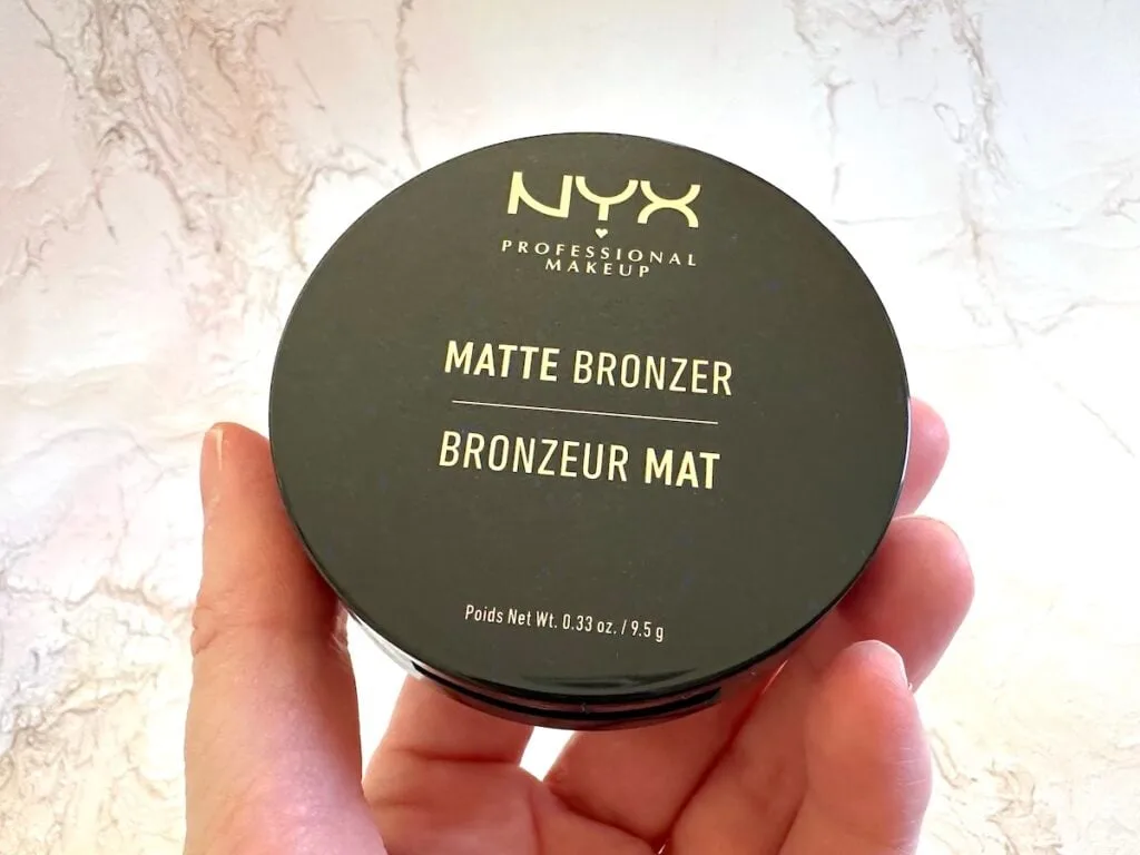 NYX Matte Bronzer in the shade Medium, handheld.