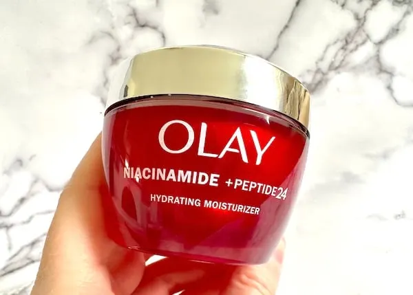 Olay Niacinamide + Peptide 24 Moisturizer, handheld.