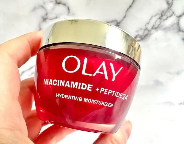 Olay Niacinamide + Peptide 24 Moisturizer, handheld.