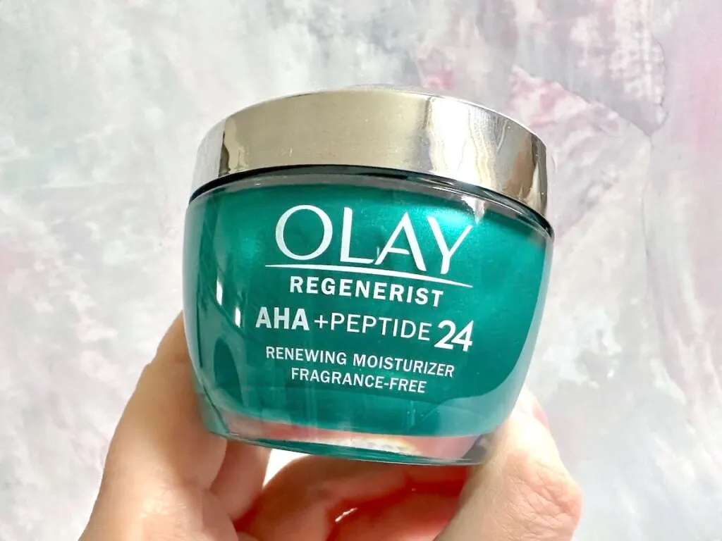 Olay AHA + Peptide 24 Face Moisturize, handheld.