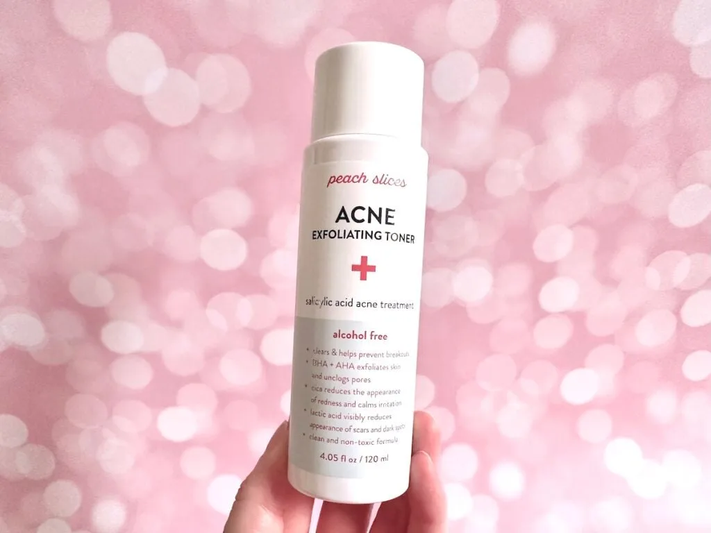 Peach Slices Acne Exfoliating Toner, handheld.