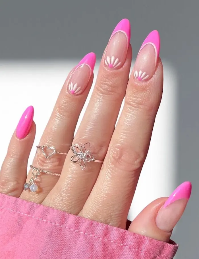 Pink French tip nails with flowers.