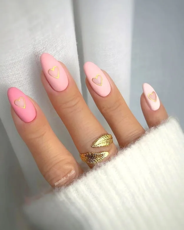 Pink and gold heart nails.