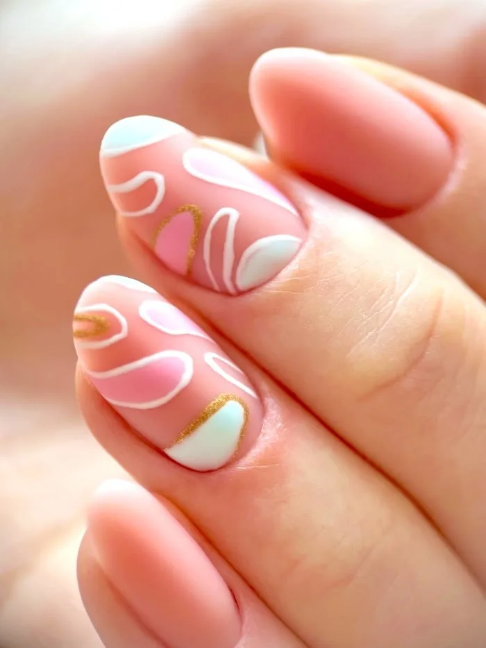 Oval pink swirl nails, closeup.