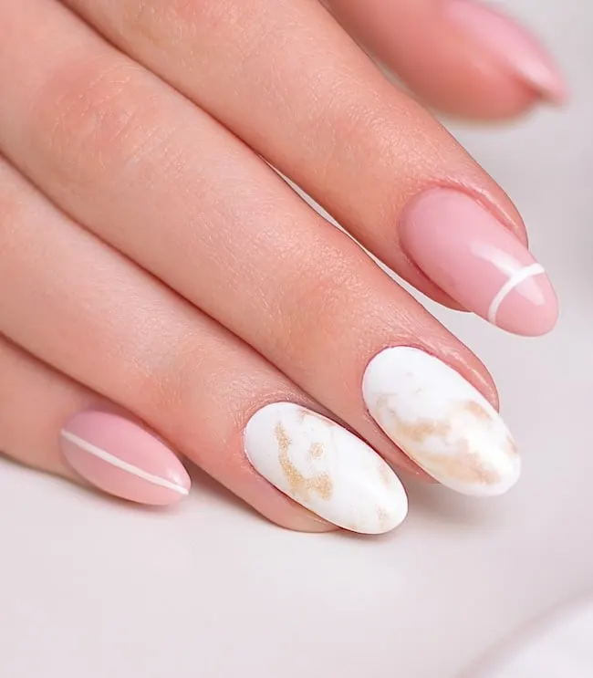 Pink, white, and gold marble nails.