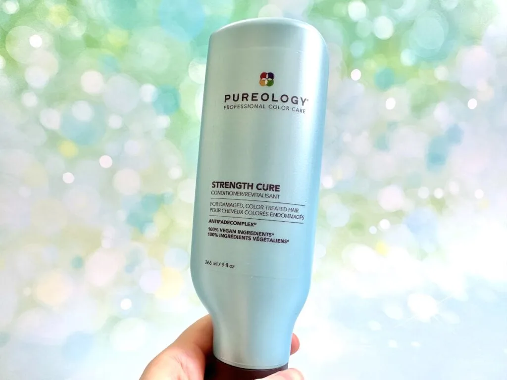 Pureology Strength Cure Conditioner, handheld.