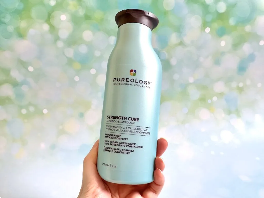 Pureology Strength Cure Shampoo, handheld.