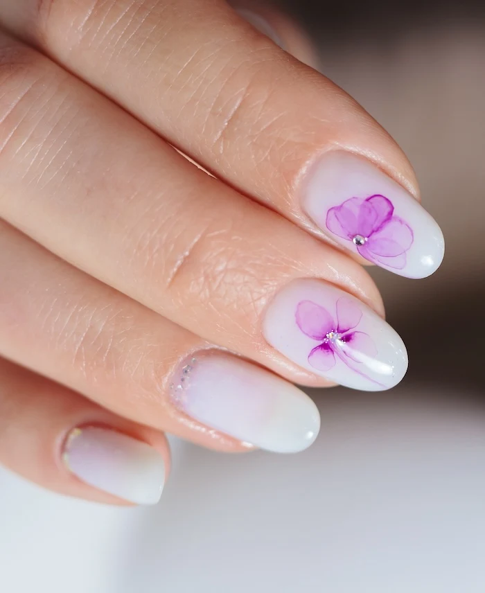 Lavender purple flower rhinestone nails.