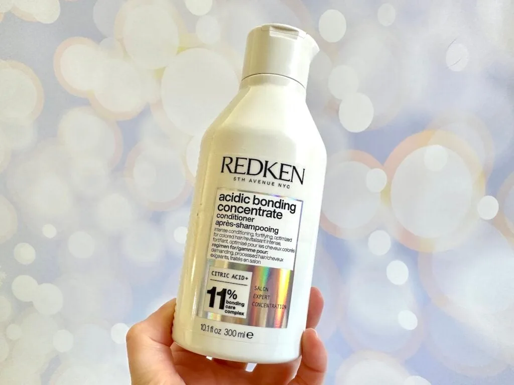 Redken Acidic Bonding Concentrate Conditioner, handheld.