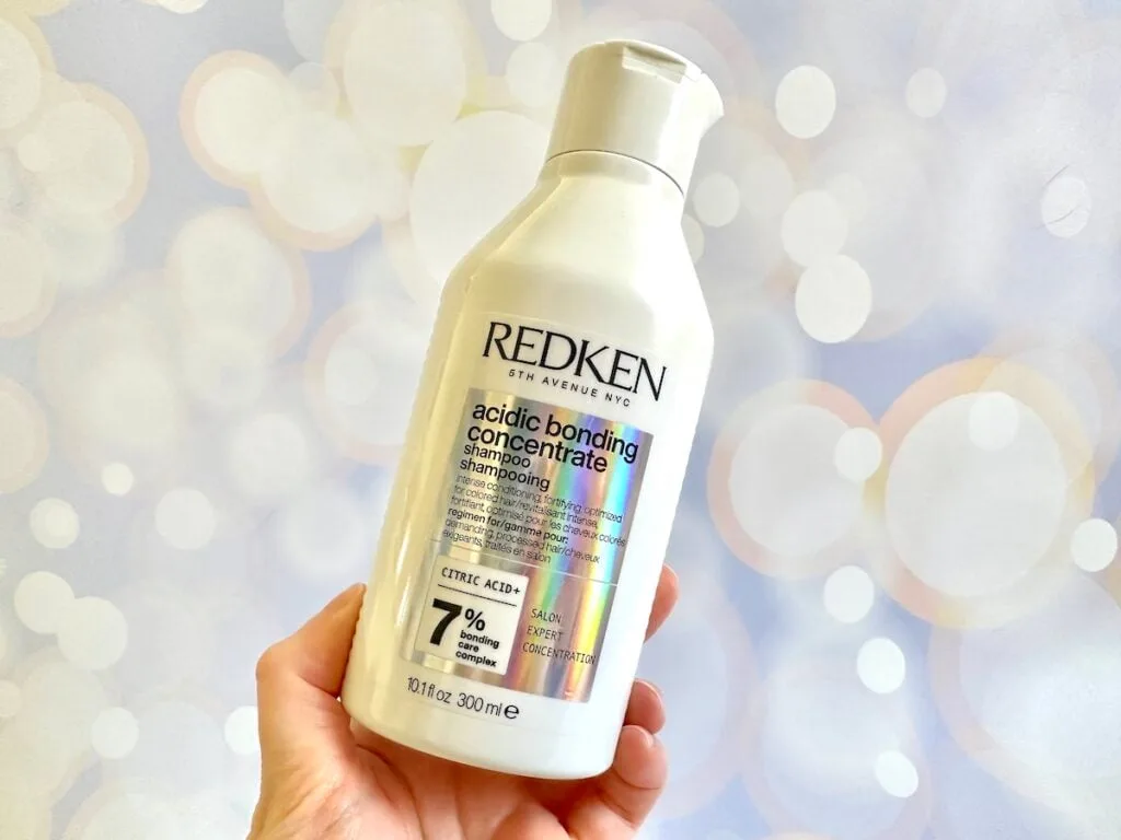 Redken Acidic Bonding Concentrate Shampoo, handheld.