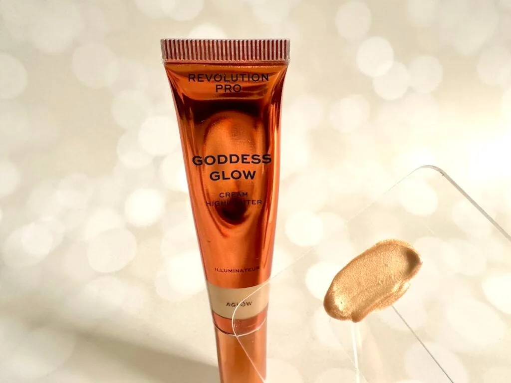 Revolution Beauty Revolution Pro Goddess Glow Cream Highlighter in the shade Aglow and highlighter sample on clear plastic spatula.