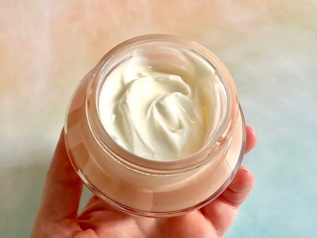 Revolution Pro Miracle Cream, open jar, handheld.