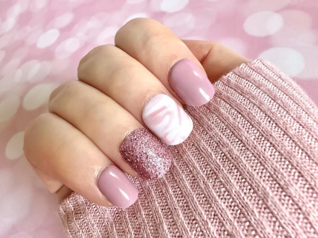 Pink and White Nails on pink sweater sleeve.