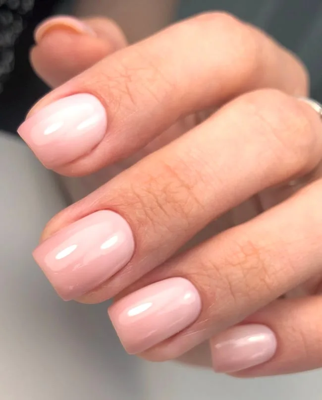 Soft pink ombre nails on short square nails.