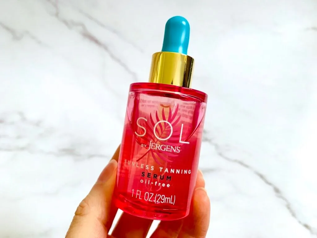 Sol by Jergens Sunless Tanning Serum held by hand