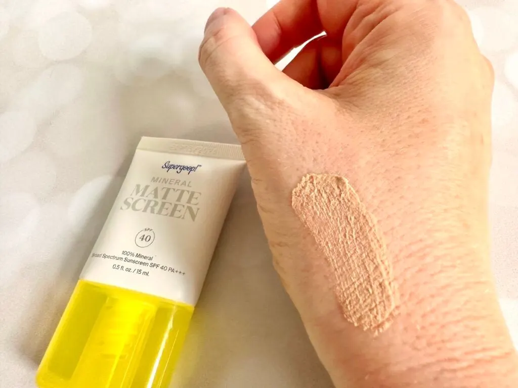 Supergoop! Mineral Mattescreen SPF 40, flatlay of tube next to sample on hand.