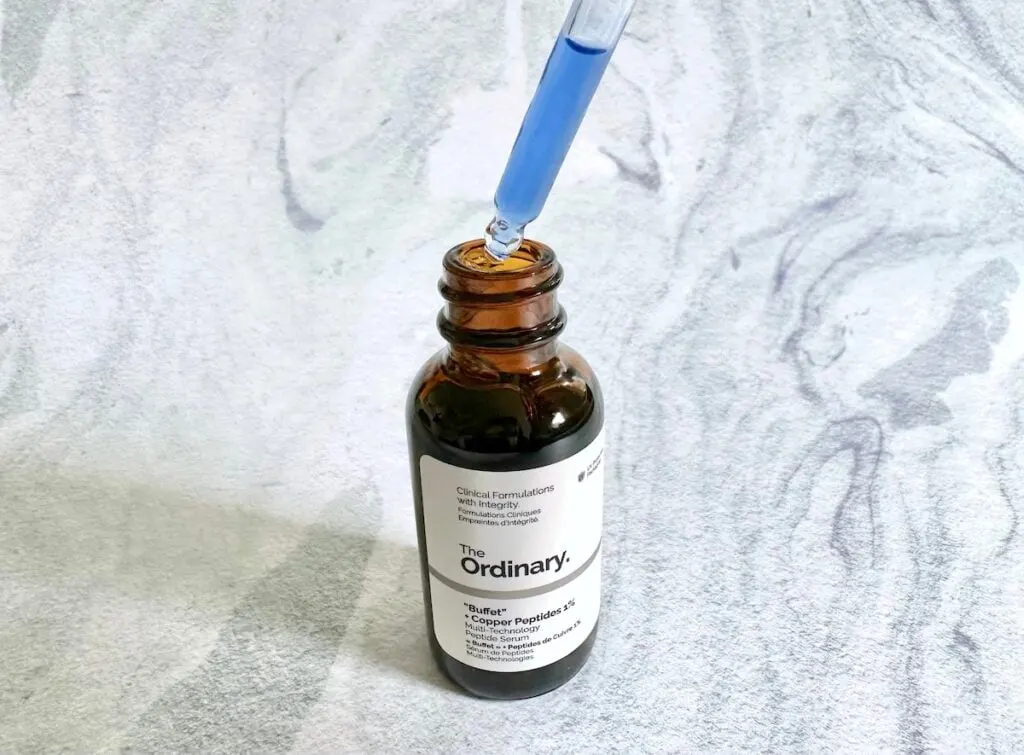 The Ordinary “Buffet” + Copper Peptides 1%, open bottle with blue serum in dropper applicator.