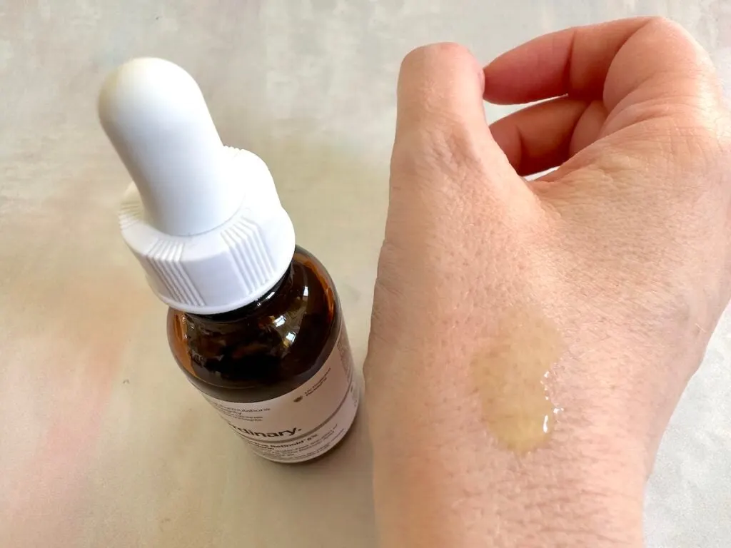 The Ordinary Granactive Retinoid 5% in Squalane bottle and serum sample on hand.