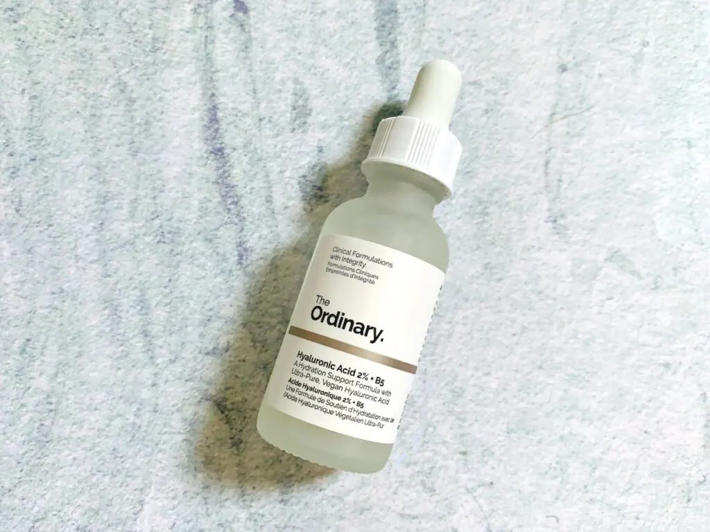 The Ordinary Hyaluronic Acid 2% + B5 Serum flatlay on a pale blue background.