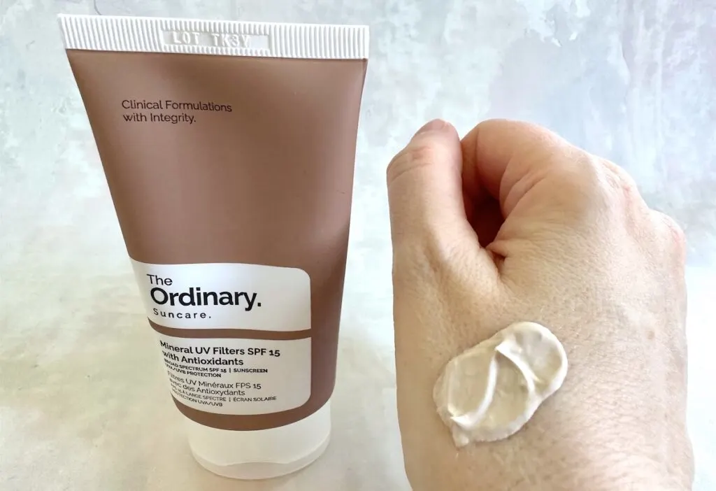 The Ordinary Mineral UV Filters SPF 15 with Antioxidants tube next to sample on hand.