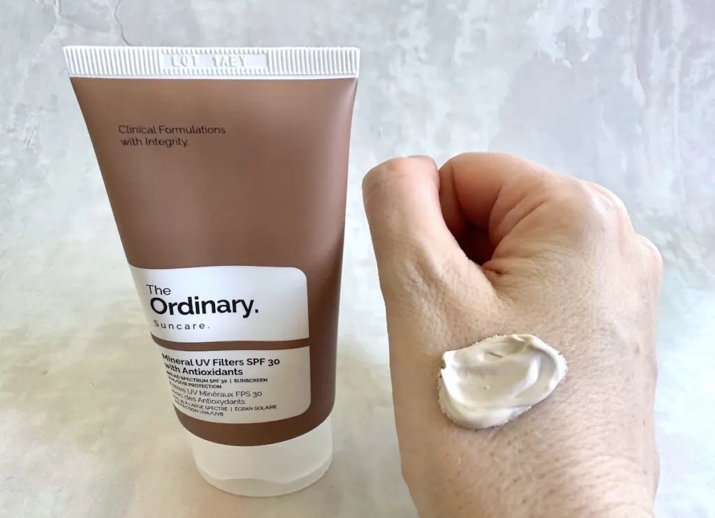 The Ordinary Mineral UV Filters SPF 30 with Antioxidants tube next to sample on hand.