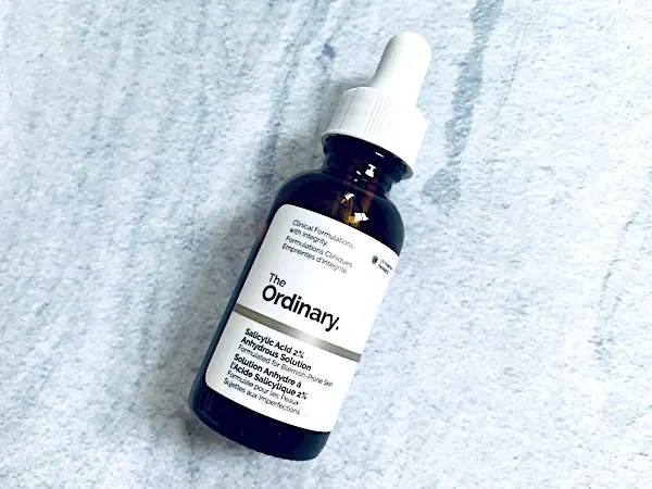 The Ordinary Salicylic Acid 2% Anhydrous Solution flatlay on blue marble background