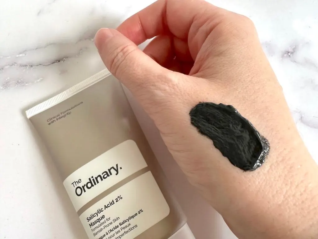 The Ordinary Salicylic Acid 2% Masque tube next to sample on back of hand.