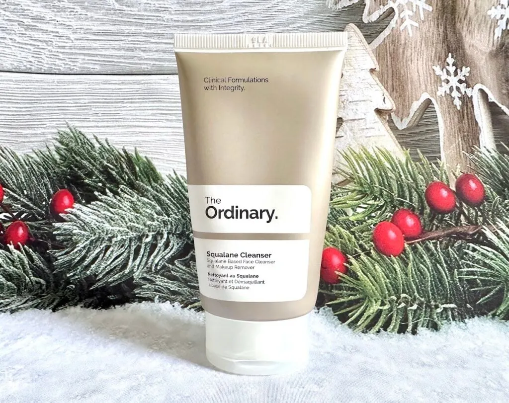 The Ordinary Squalane Cleanser, in front of Christmas holly.