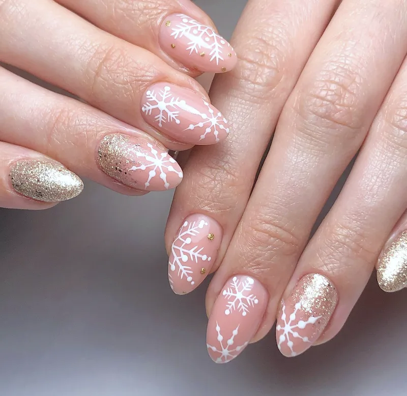 Gols and white snowflake winter nails.