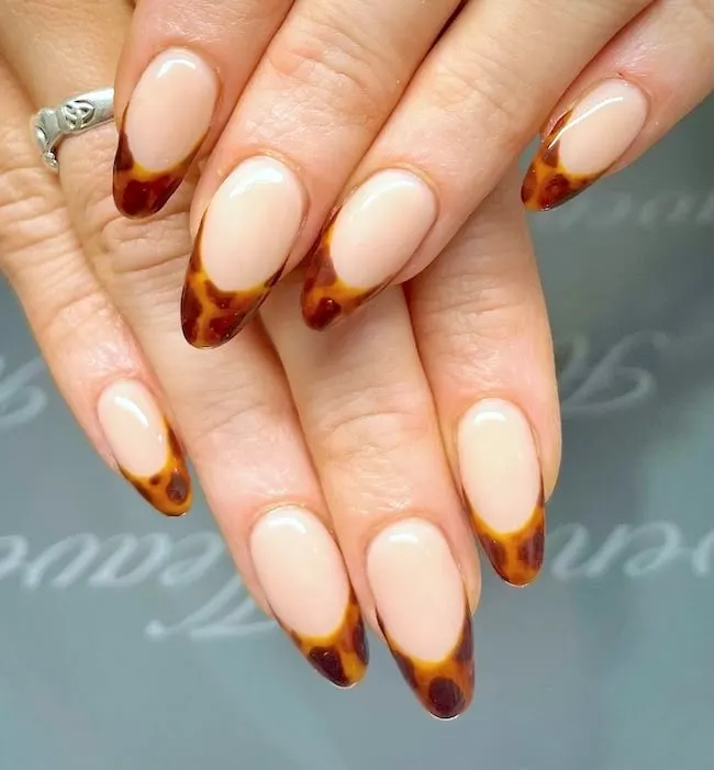 Tortoiseshell French tip nails.