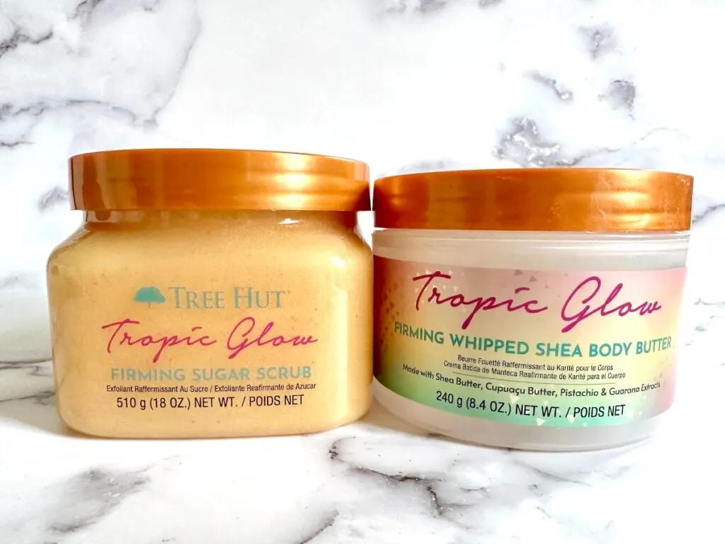 Tree Hut Tropic Glow Firming Sugar Scrub and Tree Hut Tropic Glow Whipped Shea Body Butter, side by side.