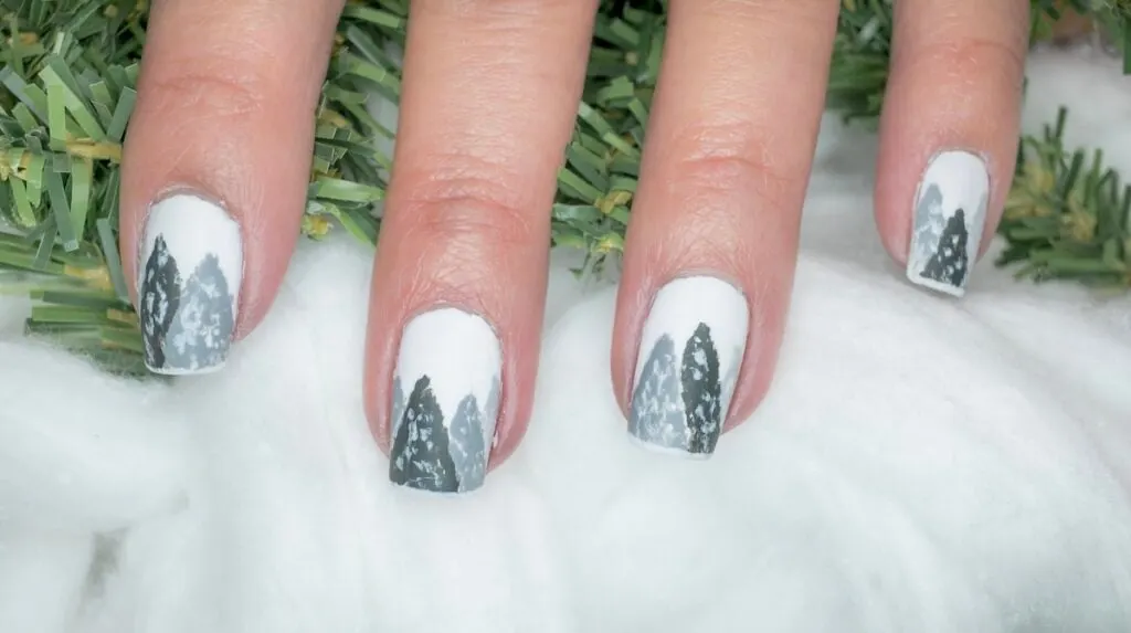 Tree nail art on white winter nails.