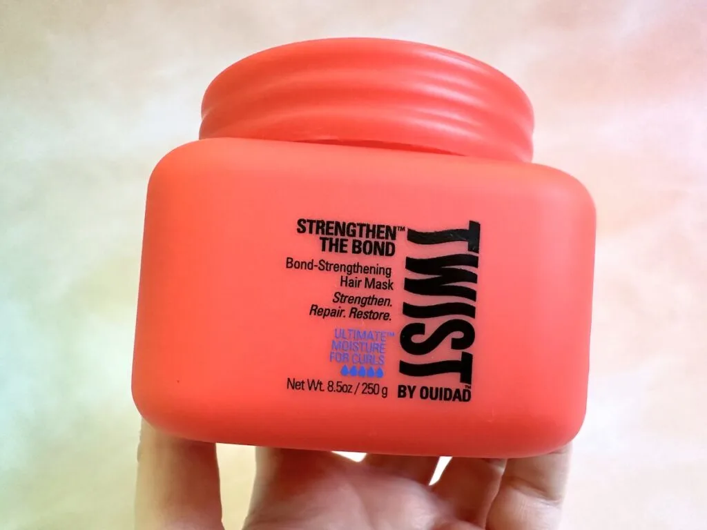 Twist Strengthen The Bond Bond-Strengthening Hair Mask, handheld.