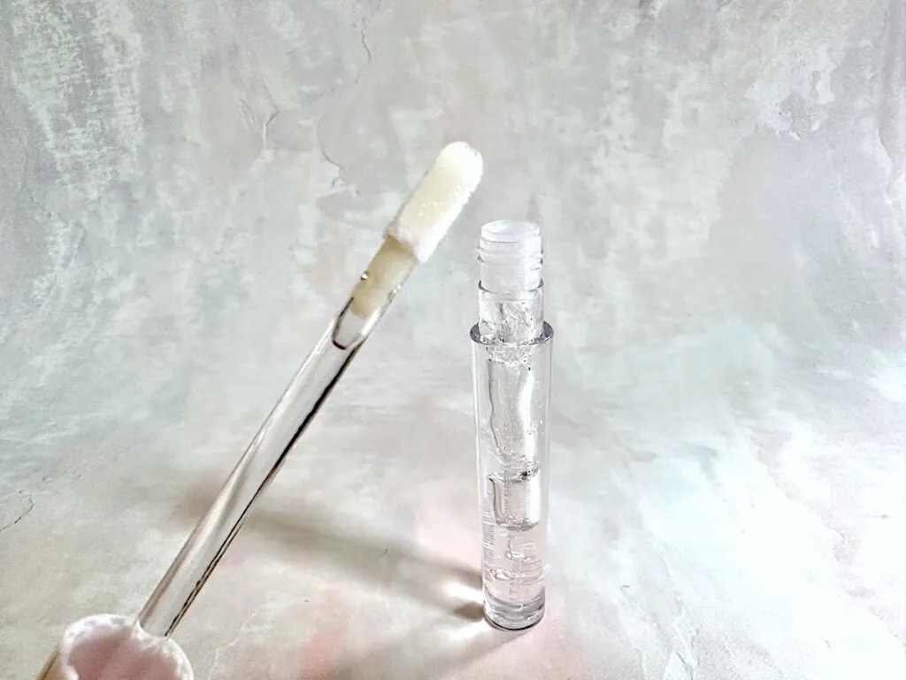 Ulta Beauty Shiny Sheer Lip Gloss in the shade Ice, open tube with applicator wand.