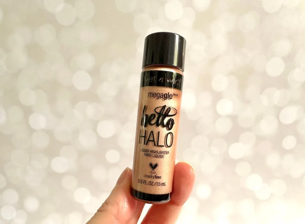 Wet n Wild MegaGlo Halo Liquid Highlighter in the shade Guilded Glow, handheld.