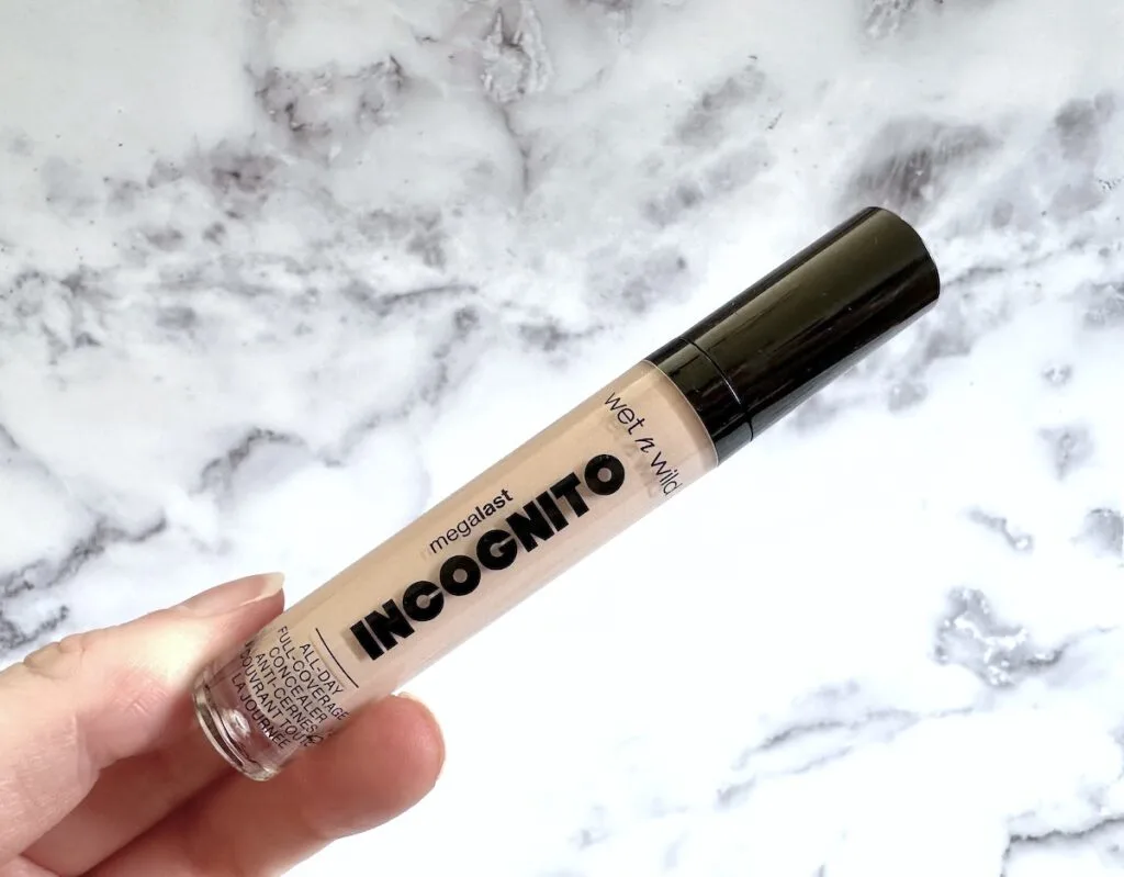 Wet n Wild Megalast Incognito All Day Full Coverage Concealer in the shade Light Beige, handheld.