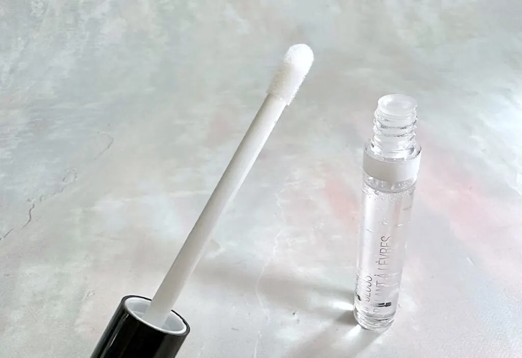 Wet N Wild Megaslicks Lip Gloss in the shade Crystal Clear, open tube with applicator wand.