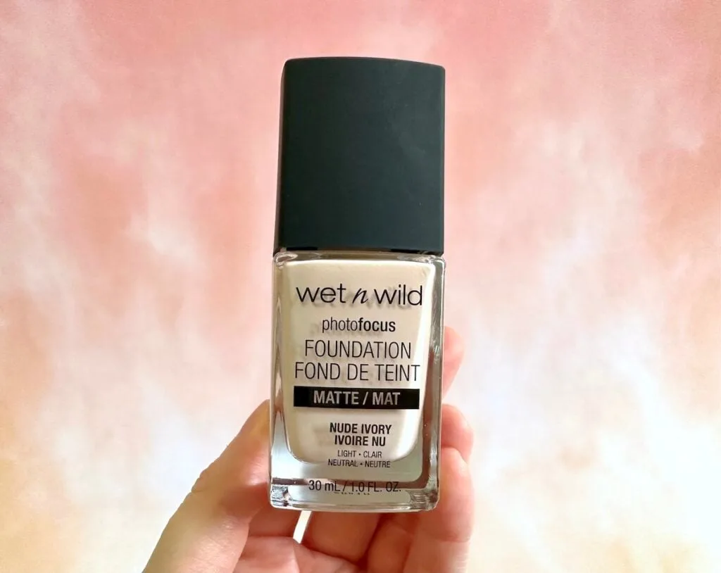 Wet N Wild Photofocus Matte Foundation in the shade Nude Ivory, handheld.